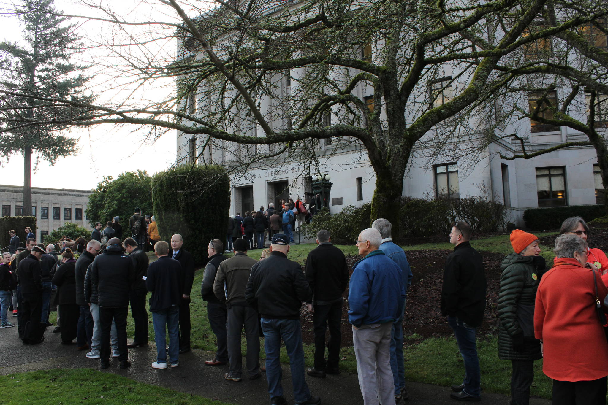 People lined up in the rain outside the Capitol’s Cherberg Building for the hearing on five gun regulation measures. Photo by Taylor McAvoy