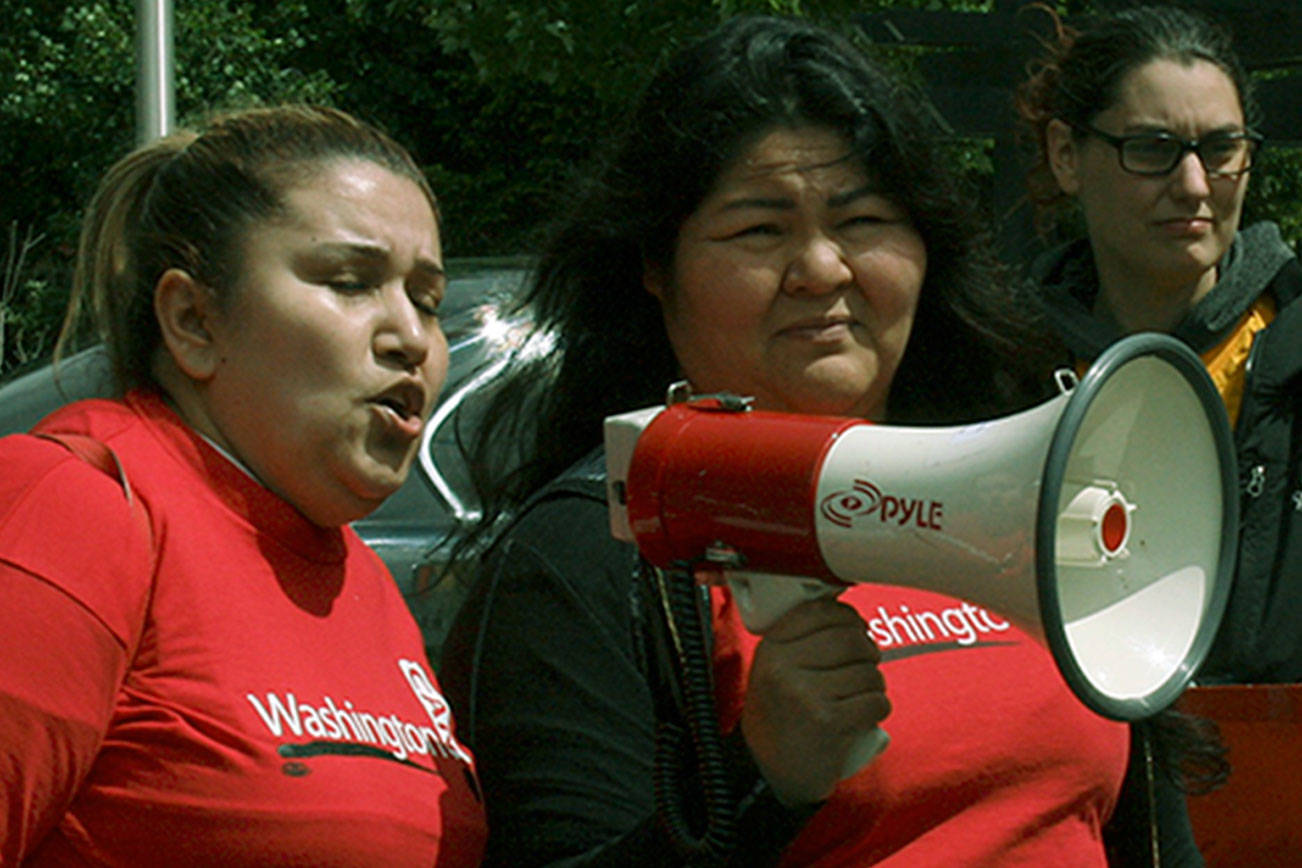 Malena Gaces, left, and other members of Washington CAN protest unfair move-out charges and alleged discriminatory behavior outside Kitts Corner Apartments in Federal Way in 2018. Sound Publishing file photo