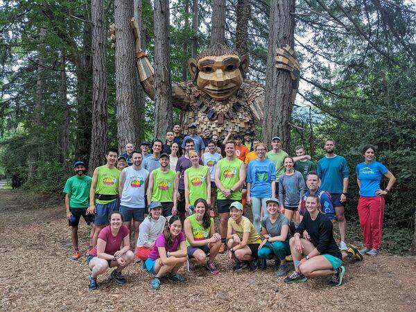 Runners celebrate their 100th run with Jakob Two Trees. (Photo courtesy of Kelly Jiang)