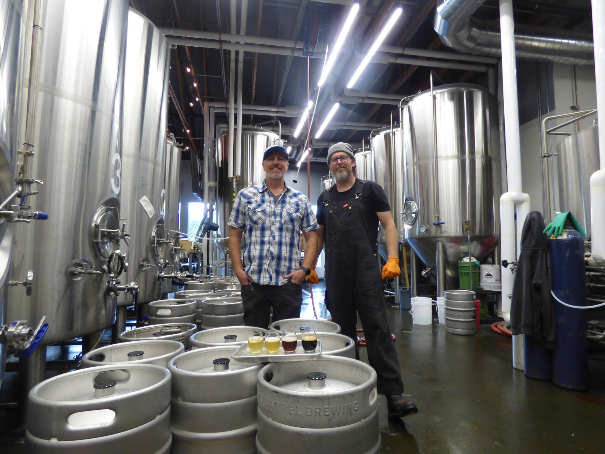 Danny Bohm (right) and Jesse Brown (left) stand over the four award-winning WBC beers in the manufactory portion of the brewery. (Cameron Sires/ Sound Publishing)