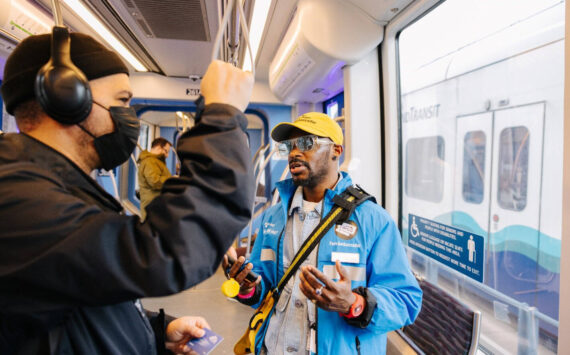 A Sound Transit fare ambassador checks with a light rail rider. COURTESY PHOTO, Sound Transit