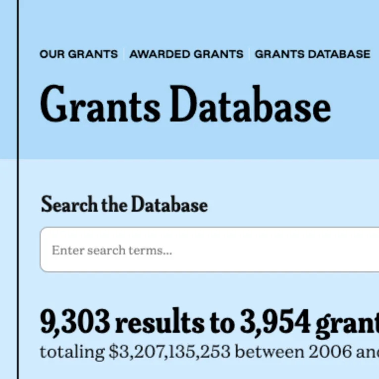 Image of a closeup of a screen with the text: Grants Database in black against a blue background and other text around it.