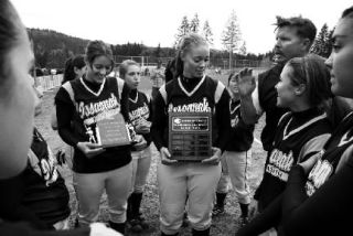 Issaquah coach Jim Magnuson congratulates his team after winning the KingCo 3A tournament Friday. Seniors Lauren Naismith