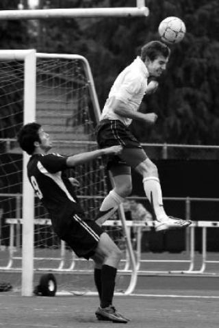 Eastlake’s Tyler Klein heads the ball away from Bellarmine’s Dylan Gaydosh Friday at Lakewood’s Harry Lang Stadium.